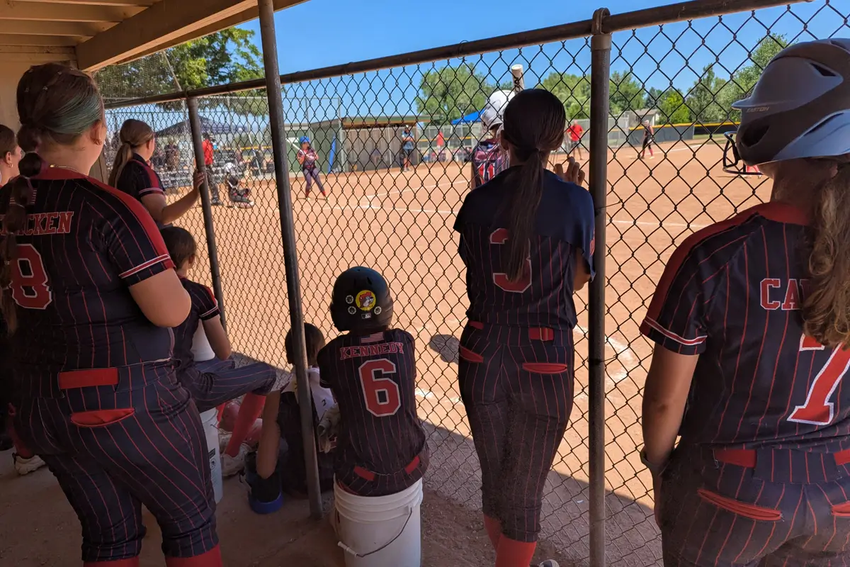 Colorado Diamonds team huddle beside the dugout